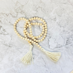 Wooden bead strand with tassels